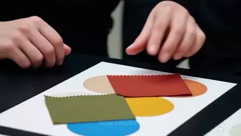 Five women in a modern meeting room discussing color swatches and a pie chart, learning about style and color theory.