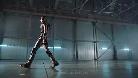 Models showcasing avant-garde and futuristic fashion on an industrial runway with dramatic lighting.