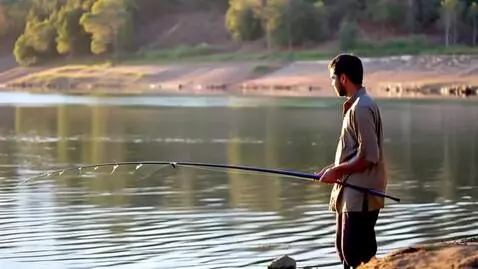 A fisherman catching fish from the lake by kandilove