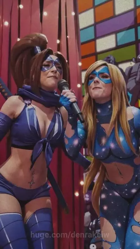 Punk superhero in blue starry suit confronts a giant crying superhero, city filled with kissing couples.