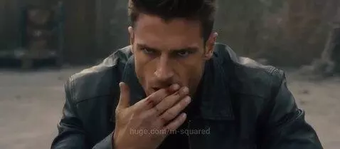 Two men in a fierce martial arts fight on a ruined urban rooftop, one in a suit, the other in a leather jacket.