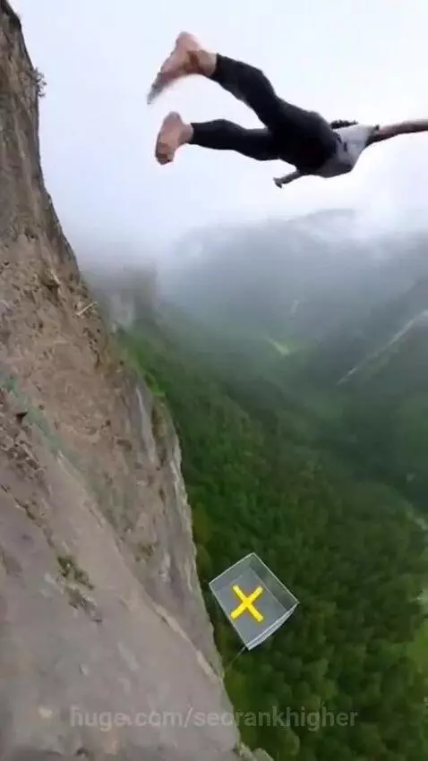 Woman barefoot on cliff edge jumps into a net below, bouncing back up.