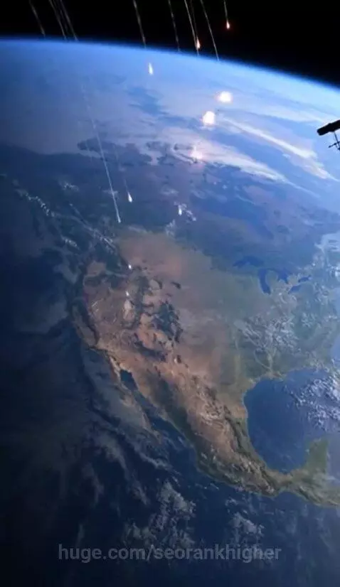 View of Earth from space with glowing objects descending and exploding over North America.