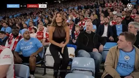 Woman in stands eating burger, then on football pitch kicking ball into goal.