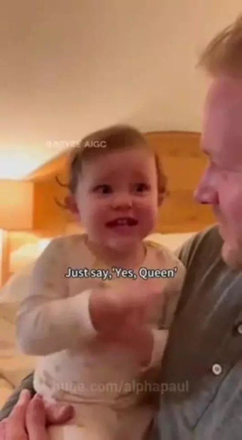 Young child in pajamas on a man's lap, animatedly giving him advice about handling Mommy when she's mad.