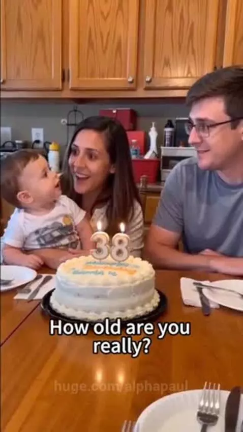 Family celebrating a birthday with a cake showing '38', a mom, dad, and young son.