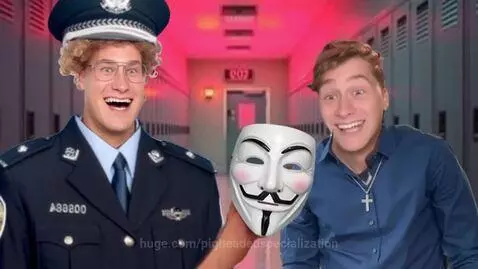Young man in a police costume and wig salutes another student holding a Guy Fawkes mask in a school hallway.