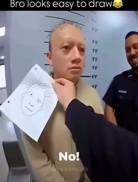 Man in hoodie laughs hysterically at a cartoon drawing that looks just like him, with a police officer smiling in the background.