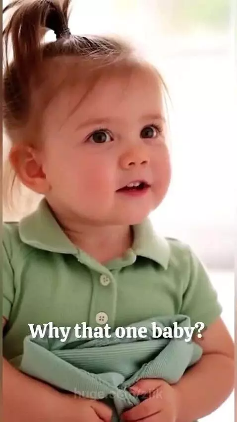 A young girl in a green shirt holds up a green garment, asking her dad to wear it so they can match.