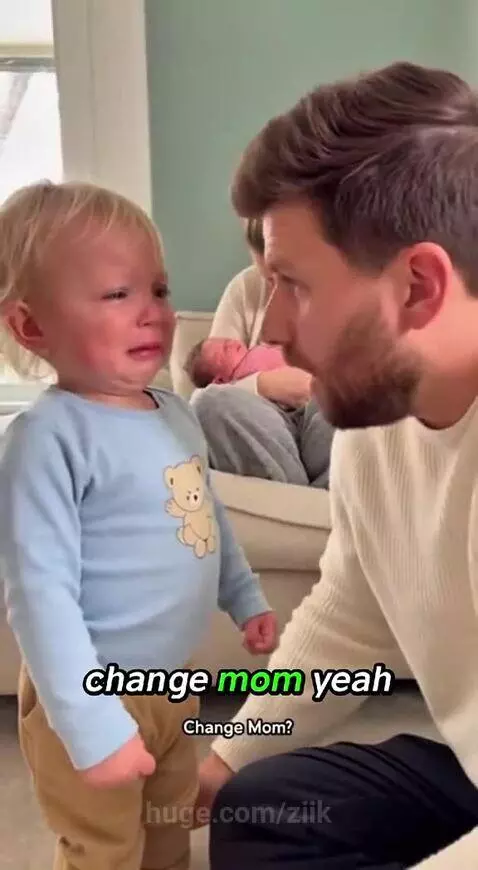 Upset toddler crying, asking dad why mom is kissing the new baby and not him.