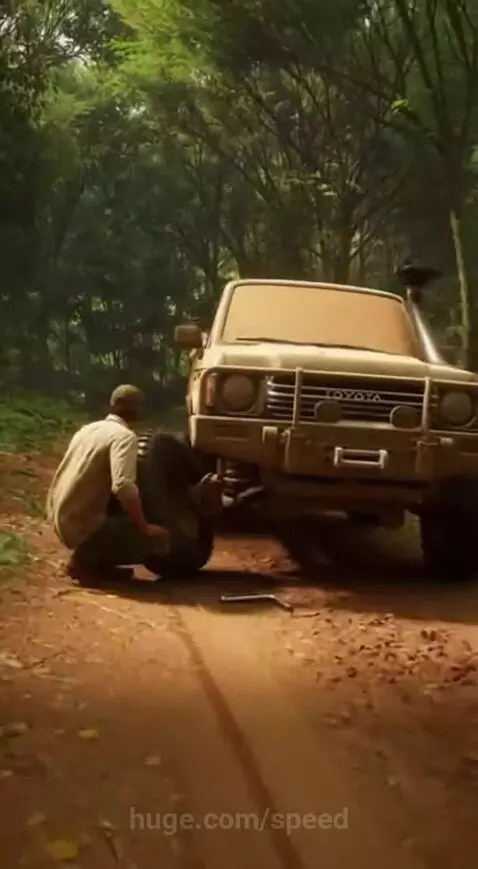 A dog barking and confronting a leopard that is lunging towards its owner on a dirt road.