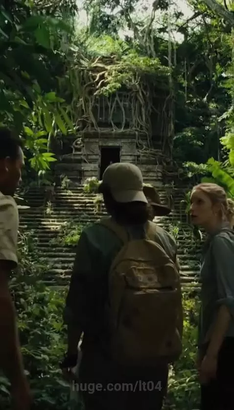Four people stand before a moss-covered ancient temple in a jungle, with roots growing over it and a figure in the entrance.