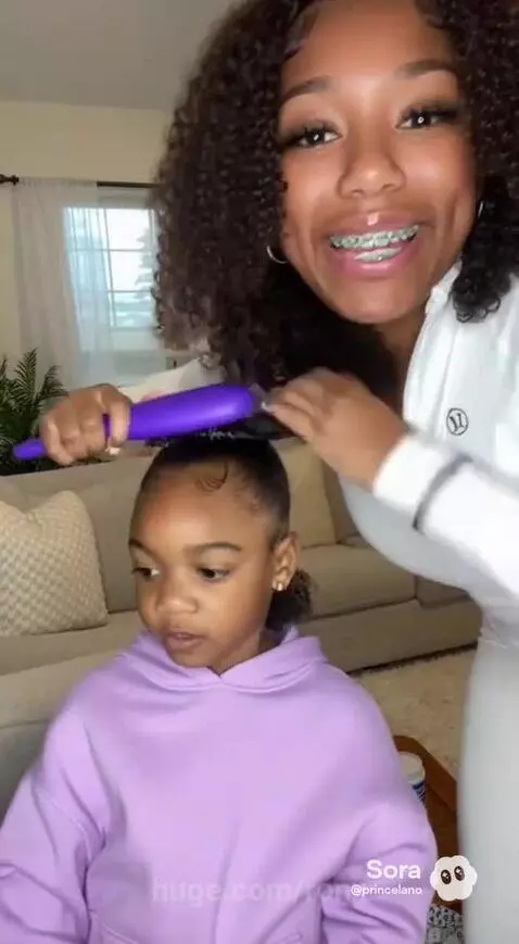 Mama making her daughter’s hair by ronx