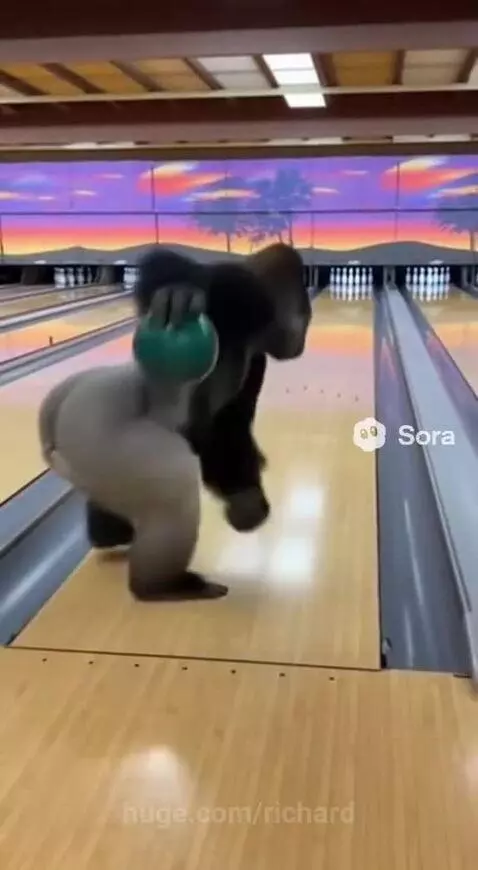 Animated gorilla in a bowling alley holding a green bowling ball, ready to bowl.
