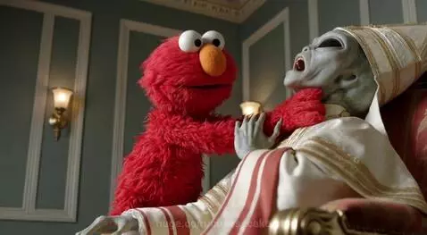 Elmo, the red puppet, choking a distressed alien in papal robes while seated in an ornate chair.