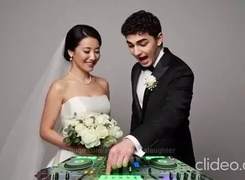 Bride and groom smiling and interacting with DJ equipment at their wedding.