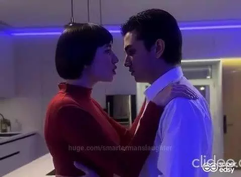 A man and woman in a kitchen, locked in an intense embrace, discussing their 'black love'.