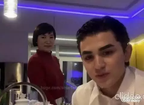 Couple in a kitchen with blue and yellow lights, engaged in an intense, dramatic conversation about love.