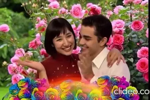 Couple embracing and kissing in a vibrant rose garden with animated hearts and rose petals.