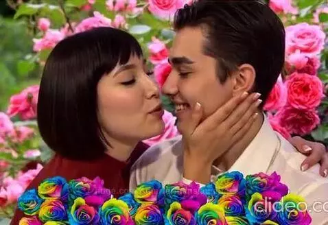 Couple embracing and kissing in a rose garden with animated hearts and rose petals.