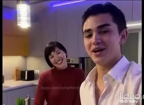 Couple dancing energetically in a modern kitchen, switching between color and black and white filters.