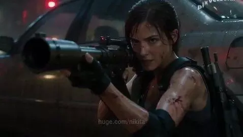 Jill Valentine fighting a large mutated monster with tentacles in a neon-lit, rainy city street.