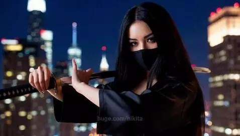 Woman with long dark hair, black mask, and kimono holding a katana on a city rooftop at night.