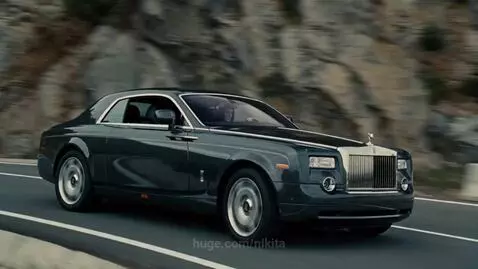 Two Rolls-Royce Phantom Coupes in a dramatic chase on a coastal road, one forced towards a cliff edge.