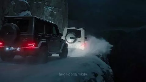 Two Mercedes-Benz G-Wagons drifting on a snowy mountain road at night, kicking up snow.