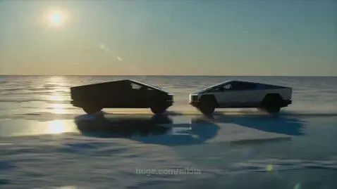Two Tesla Cybertrucks racing side-by-side at high speed on a vast, frozen lake under a bright sun.