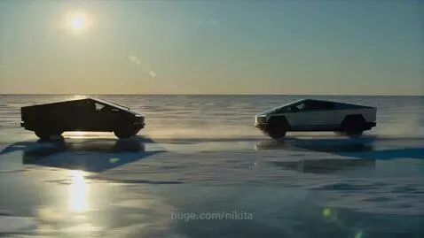 Two Tesla Cybertrucks racing side-by-side at high speed on a vast, frozen lake under a bright sun.