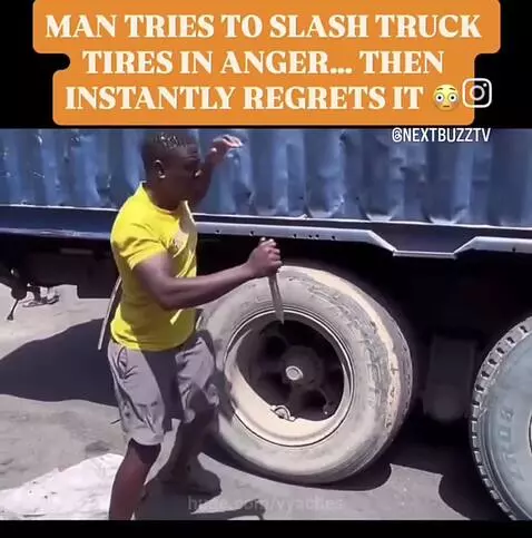 Man in yellow shirt thrown backward after truck tire explodes from knife attack.