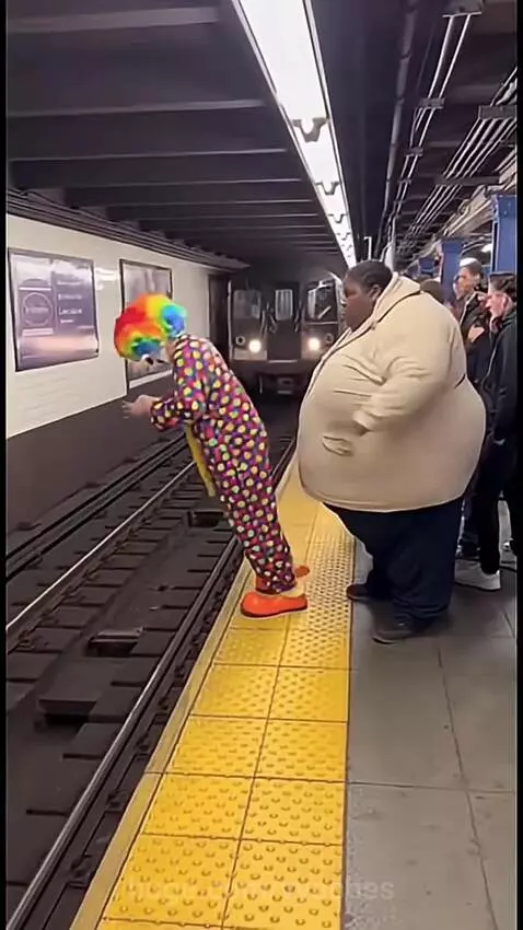 Person in clown costume pushed onto subway tracks as train approaches, followed by another push incident.