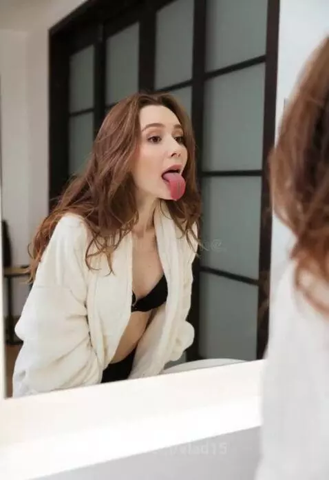 A girl makes faces in front of a mirror by vlad15