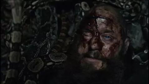 Ragnar Lothbrok's bloodied face surrounded by snakes in a pit, depicting his death in Vikings.