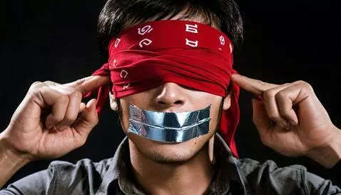 Man blindfolded with duct tape over mouth, juxtaposed with images of wealth and societal control.