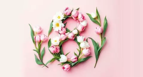 Robot transforms into a man and proposes to a woman with roses and a ring, celebrating International Women's Day.