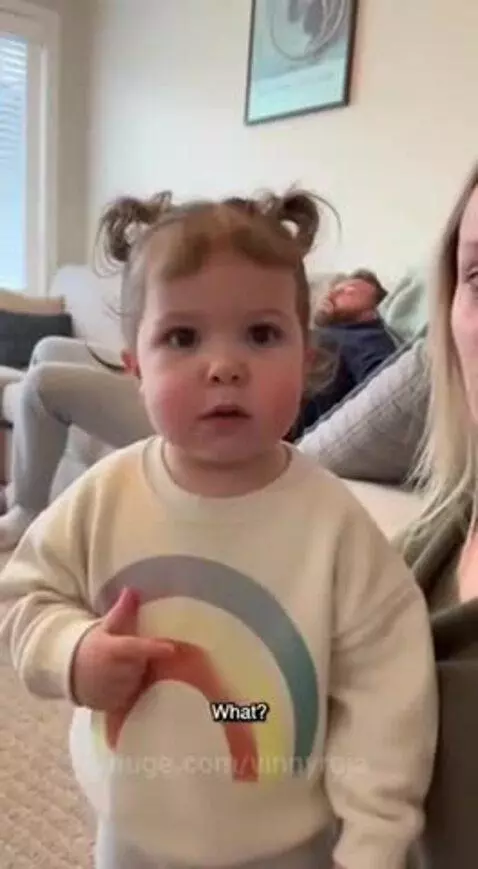 Young girl with pigtails in a rainbow sweater tells her dad to get a job.