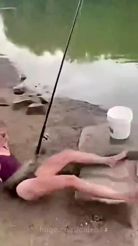 Woman fishing is attacked by a large snake that wraps around her body.