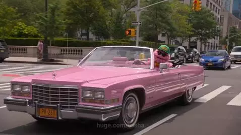 Animated puppets, including a pink puppet, green puppet, and alien, dancing and playing instruments on a city street.