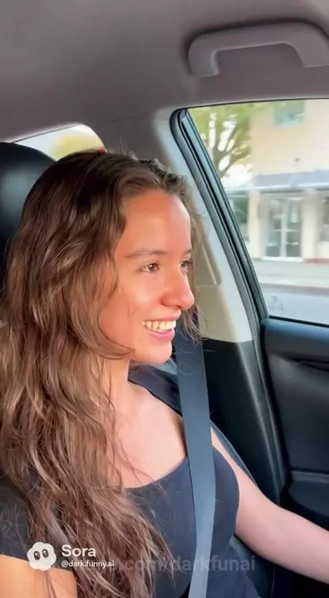 Smiling couple in a car, woman playfully teases man about his accent.