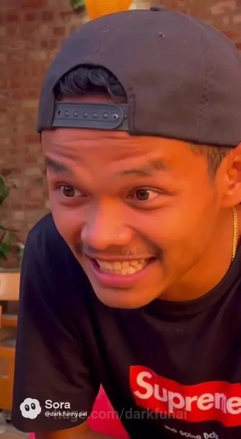 Man in a restaurant telling a story to a woman who is laughing.