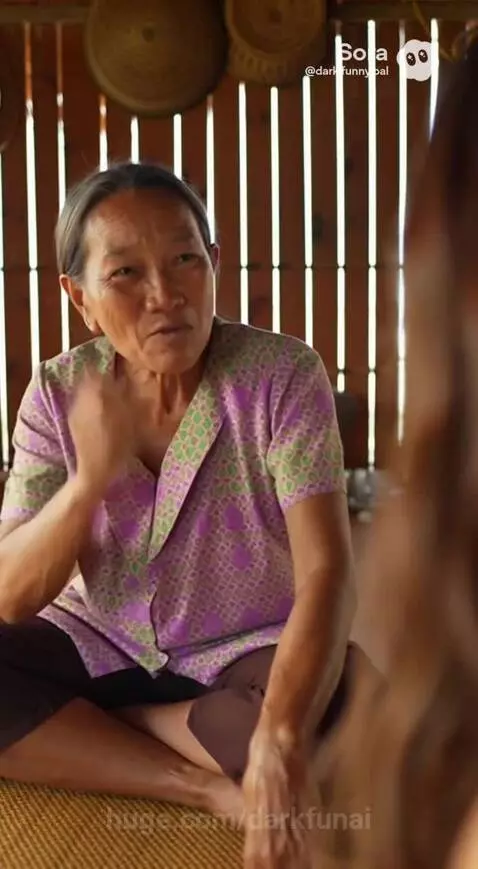 Two women laughing; an older woman tells a story about a Facebook scam to a younger woman.