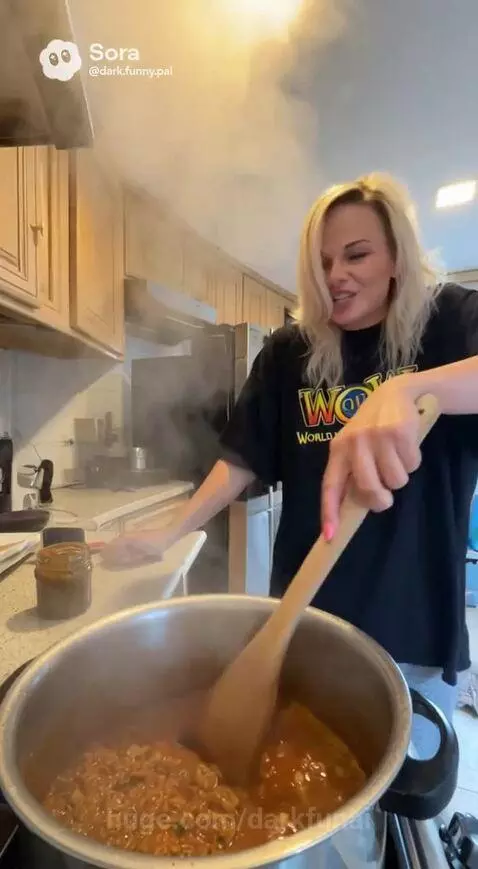 Couple playfully arguing in a kitchen, woman cooking, man on couch.