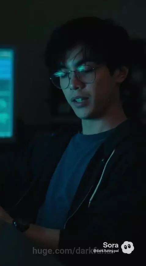 Woman in lab coat looks concerned at glowing substance in apparatus, man discusses anomaly.