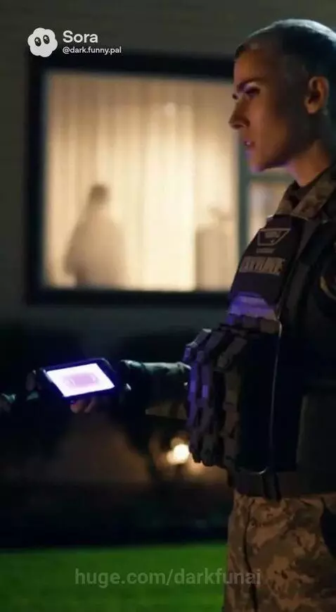 Night scene: Individuals in tactical gear investigate a circular burning patch on the ground with purple grid projections.