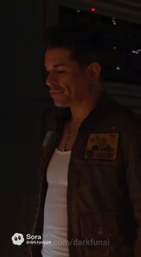 Man in jacket and insectoid alien in dimly lit futuristic corridor with glowing panels.