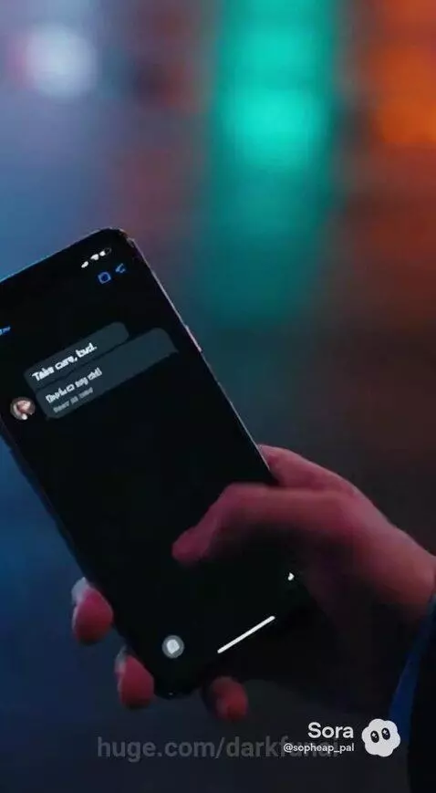 Man in suit shouting in city at night, woman singing on rooftop with city lights.