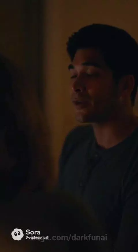 A man and woman share a kiss in a cozy room after discussing a new job opportunity.