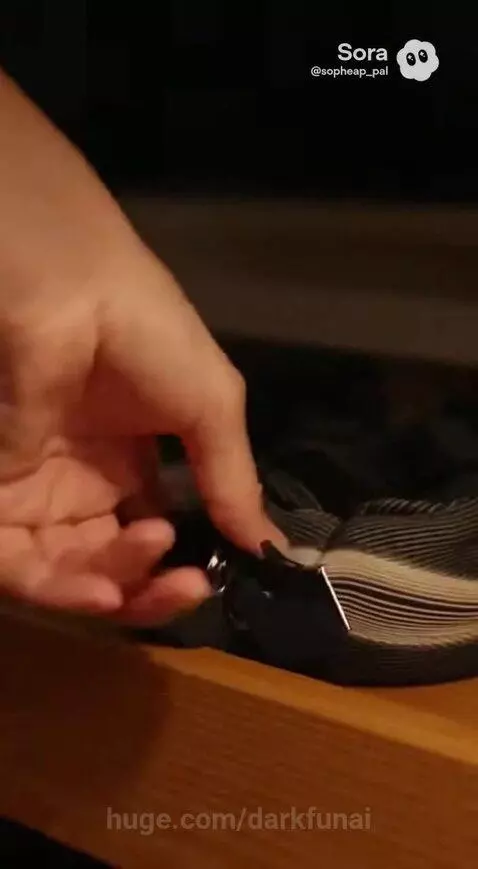 Woman in a glowing blue futuristic superhero suit jumping from a balcony at night.